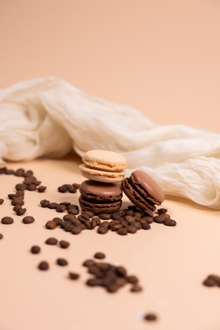 Chocolate and vanilla macarons among coffee beans